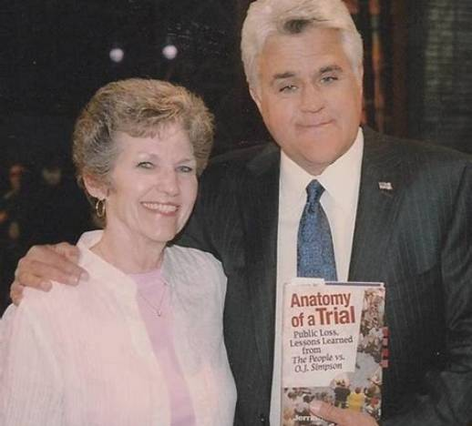 Jerrianne Hayslett standing beside Jay Leno on a television studio set; Leno holds a copy of her book Anatomy of a Trial: Public Loss, Lessons Learned from The People v. O.J. Simpson.